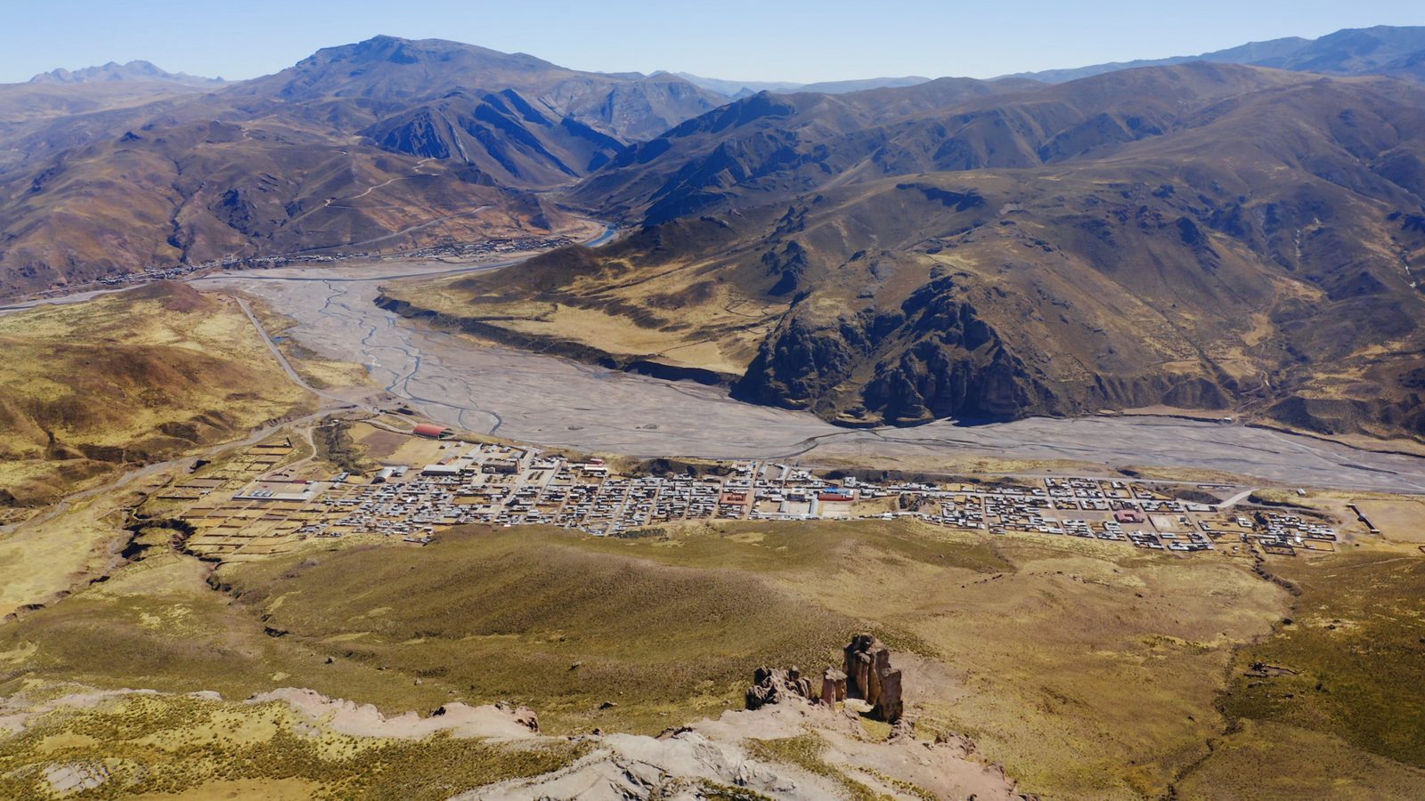 A town on the terrace above the river, seen from the canyon rim